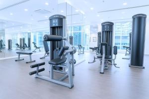 a gym with a row of exercise bikes and treadmills at Cormar Suites Kuala Lumpur in Kuala Lumpur
