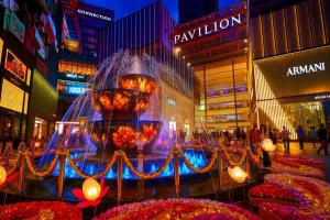 a large fountain in the middle of a city at night at Cormar Suites Kuala Lumpur in Kuala Lumpur