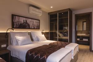 a bedroom with a large bed with white pillows at Guesthouse Grof in Vransko