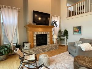 a living room with a fireplace and a tv at Mississippi waterfront getaway-Dogs Welcome! in Brownsville