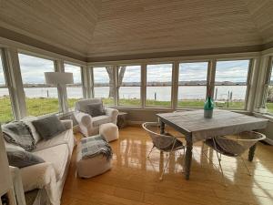 a living room with a couch and a table with chairs at Mississippi waterfront getaway-Dogs Welcome! in Brownsville