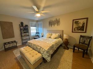 a bedroom with a bed and a ceiling fan at Mississippi waterfront getaway-Dogs Welcome! in Brownsville