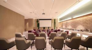 a conference room with chairs and a projection screen at Lavande Hotel Wuhan Jianghan Road Dunli Gate Metro Station in Wuhan