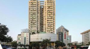 a large tall building in a city at Lavande Hotel Wuhan Jianghan Road Dunli Gate Metro Station in Wuhan
