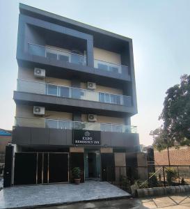 a tall black building with a sign on it at Expo Residency Inn in Jāmb