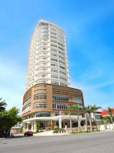 een hoog gebouw met een auto ervoor geparkeerd bij Stay Hotel in Da Nang