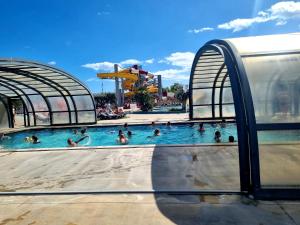 a group of people in a pool at a water park at Camping les dunes Torreilles Plages - Bungalow M027 chez D&D in Torreilles +18 photos