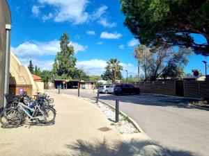 a group of bikes parked next to a street at Bungalow M027 chez D&D in Torreilles