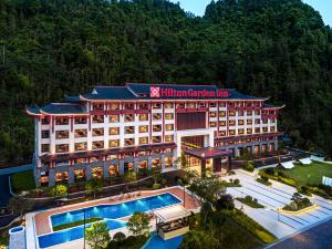 an aerial view of a hotel with a swimming pool at Hilton Garden Inn Zhangjiajie Wulingyuan in Zhangjiajie