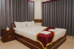 Ένα ή περισσότερα κρεβάτια σε δωμάτιο στο Baral Richmart Resthouse