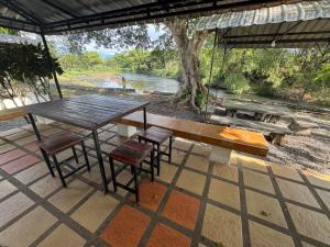 ริเวียร่า วิลล่า นครนายก في Ban Sarika: طاولة وكراسي نزهة على فناء يطل على نهر