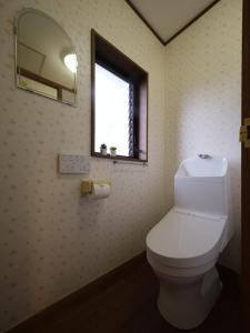 a bathroom with a toilet and a window at 熱海絶景温泉宿 kintsugi 宙 in Wada +27 photos