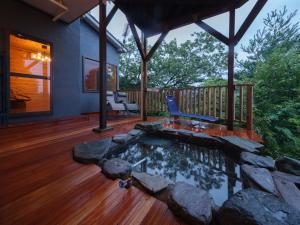a house with a pool on a wooden deck at 熱海絶景温泉宿 kintsugi 宙 in Wada