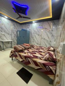 a large bed in a room with a ceiling at Luxury Heaven Hostel for students, parents and guests in Chaheru +8 photos