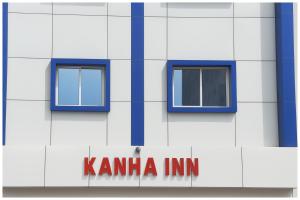 a white building with blue windows and a karma inn sign at Kanha Classic Inn Near Lucknow Railway Station # Free Wifi # Room Service And Parking Facility - Fully Air conditioning Premium Room - Best Premium Hotel In Lucknow in Lucknow
