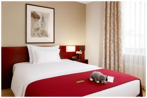 a stuffed elephant sitting on a bed in a hotel room at Kanha Classic Inn Near Lucknow Railway Station # Free Wifi # Room Service And Parking Facility - Fully Air conditioning Premium Room - Best Premium Hotel In Lucknow in Lucknow