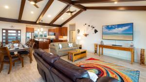 a living room with a couch and a table at ❤PiH❤ Sunset Breeze Resort Pool Waterslide Passes Included Bikes in Waikoloa