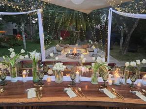 a table with candles and flowers on it at Tulum Private Villa, Weddings, Retreats, Groups in Tulum