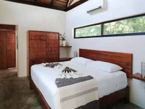 a bedroom with a large bed with white sheets at Tulum Private Villa, Weddings, Retreats, Groups in Tulum +36 photos