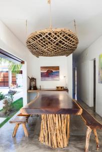 a dining room with a wooden table and a hanging basket at Tulum Private Villa, Weddings, Retreats, Groups in Tulum