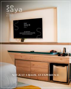 a tv on a wall in a room at SeSaya Poshtel & Bistro - Colombo's Newest and Finest Poshtel Dorms and Rooms in Colombo