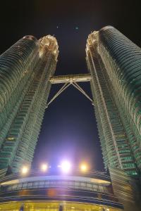two tall skyscrapers at night with the sky at Cormar Residences Kuala Lumpur in Kuala Lumpur