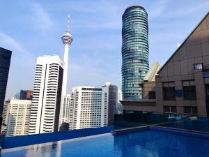a view of theuckland city skyline from a swimming pool at Cormar Residences Kuala Lumpur in Kuala Lumpur +12 photos
