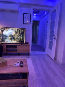 a living room with a large flat screen tv at Barış Apart in Dalaman
