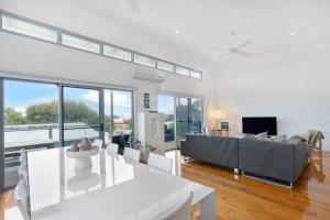 a living room with a couch and a table at 65 McLeod Rd Middleton Pet Friendly Wi-Fi - No Linen Included in Middleton