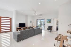 a living room with a couch and a tv at 65 McLeod Rd Middleton Pet Friendly Wi-Fi - No Linen Included in Middleton