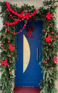 a blue door with a christmas wreath at "Breeze" Aparthotel by Parrot`s House in Lloret de Mar