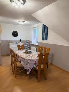 a dining room with a table and a christmas tree at Gîte au secret des vignes in Bergholtz +14 photos