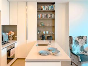 a kitchen with a counter with two plates on it at Aspire Boutique Condo Melbourne CBD in Melbourne