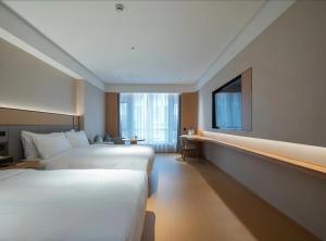 Postel nebo postele na pokoji v ubytování JI Shanghai International Tourism Liufeng Highway Hotel + 22 fotografií