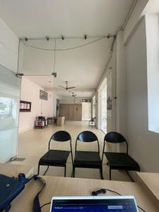 a room with two chairs and a table with a laptop at Luxury Heaven Hostel for students, parents and guests in Chaheru