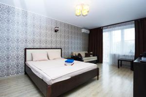 a bedroom with a bed with a blue book on it at ApartLux 1905 goda Suite in Moscow