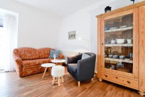 a living room with a couch and a chair at Fewo Jule in Norderney +1 photo