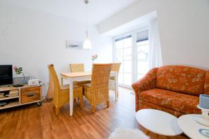 a living room with a couch and a table at Fewo Jule in Norderney