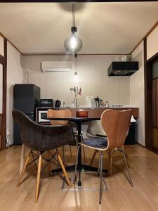 a kitchen with a table and chairs in a room at Newopen 一棟貸切宿YUNOWA 車3台駐車可 6名様まで同料金 in Nagato