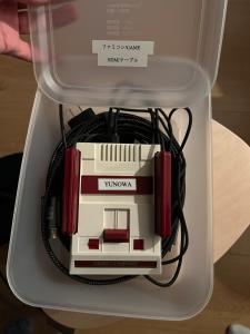 a box with a router with red headphones in it at Newopen 一棟貸切宿YUNOWA 車3台駐車可 6名様まで同料金 in Nagato