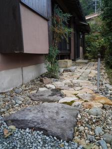 a stone walkway in front of a building at Newopen 一棟貸切宿YUNOWA 車3台駐車可 6名様まで同料金 in Nagato