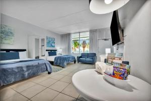 a hotel room with a bed and a table in a room at Sunset Suite - Private Balcony Gym & Pool in Ruskin
