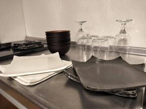 um balcão de cozinha com taças de vinho e pratos sobre ele em Zen Stay Benten 6guests Easy access to Umeda Shinsaibashi USJ em Wada mais 68 fotografias