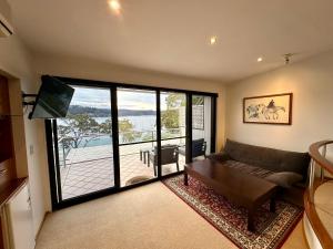 a living room with a couch and a large window at BlueWater Penthouse GuestSuite 2 in Newport