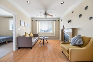 a living room with two couches and a fireplace at Cozy Stay in Metrotown Steps to SkyTrain in Burnaby