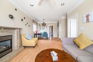 a living room with a couch and a fireplace at Cozy Stay in Metrotown Steps to SkyTrain in Burnaby