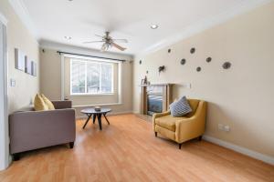 a living room with two chairs and a fireplace at Cozy Stay in Metrotown Steps to SkyTrain in Burnaby