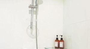 a shower in a bathroom with two bottles of alcohol at Sans Hotel in Ban Rong Chang +92 photos