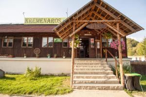a building with stairs in front of a store at Kremenaros in Ustrzyki Górne