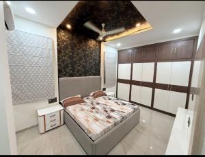 a bedroom with a bed and a ceiling fan at Madhav Villa in Jaipur